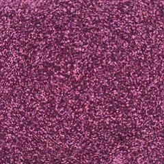 Side view of Fairy Dust loose glitter in a clear jar with silver cap, showcasing fine shimmer particles catching light