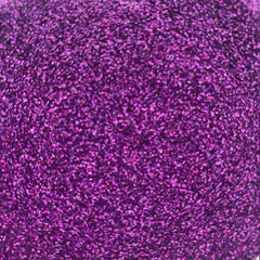 Side view of loose glitter eye shadow in a sleek silver sifter jar, showcasing fine shimmer particles