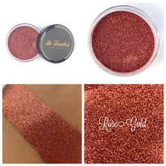 Glass jar of sparkling rose gold loose glitter eye shadow with metallic sheen
