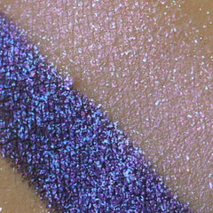 Violet purple holographic eye shadow powder in round compact with shimmering iridescent finish