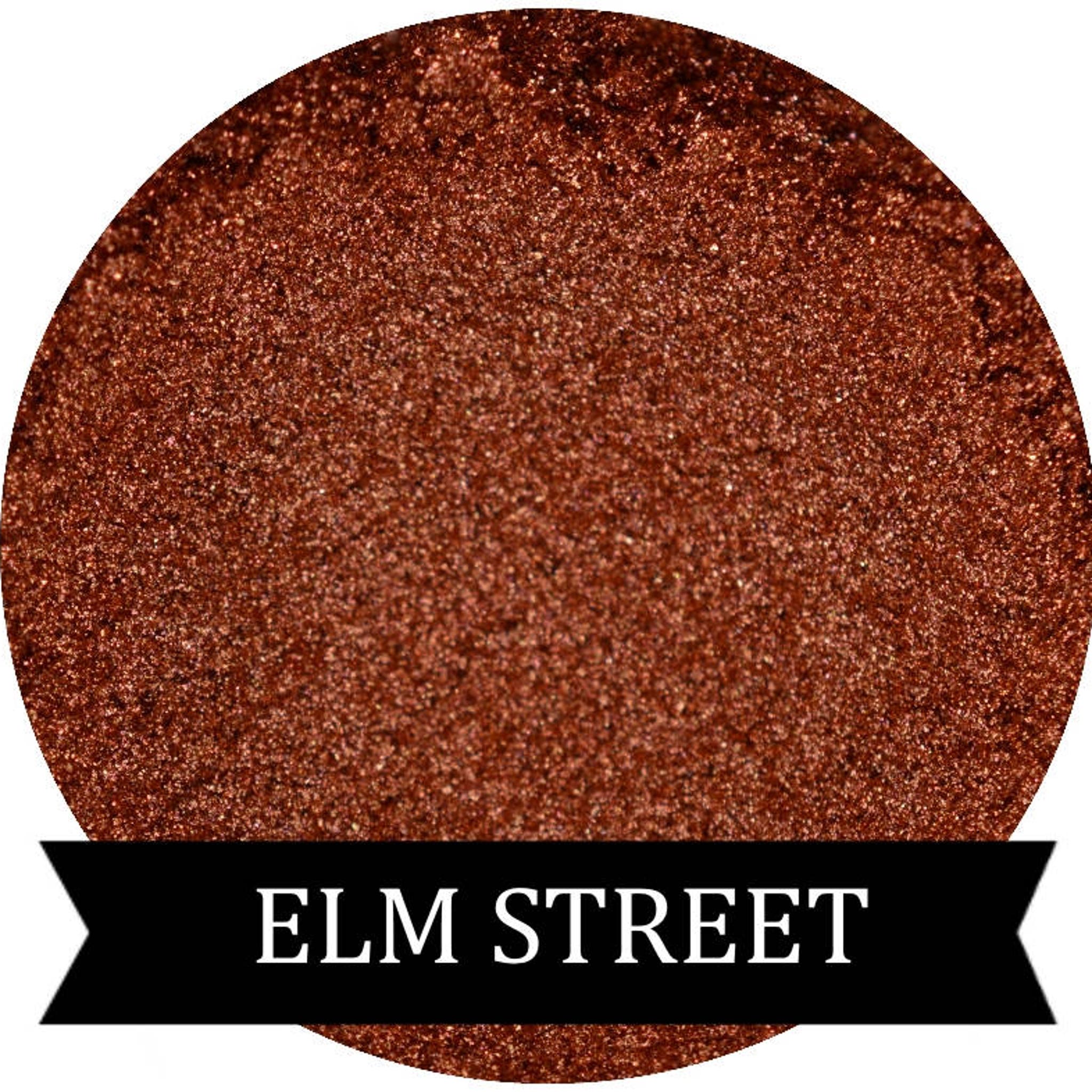 Close-up of ELM STREET Halloween Collection copper orange eyeshadow pan with shimmer finish