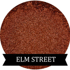 Close-up of ELM STREET Halloween Collection copper orange eyeshadow pan with shimmer finish