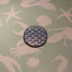 Close-up of Atlantis Eye Shadow in a vibrant teal shade with shimmer finish, displayed in a compact case.