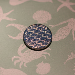 Close-up of shimmery teal Atlantis Eye Shadow with smooth, pigmented texture in compact case