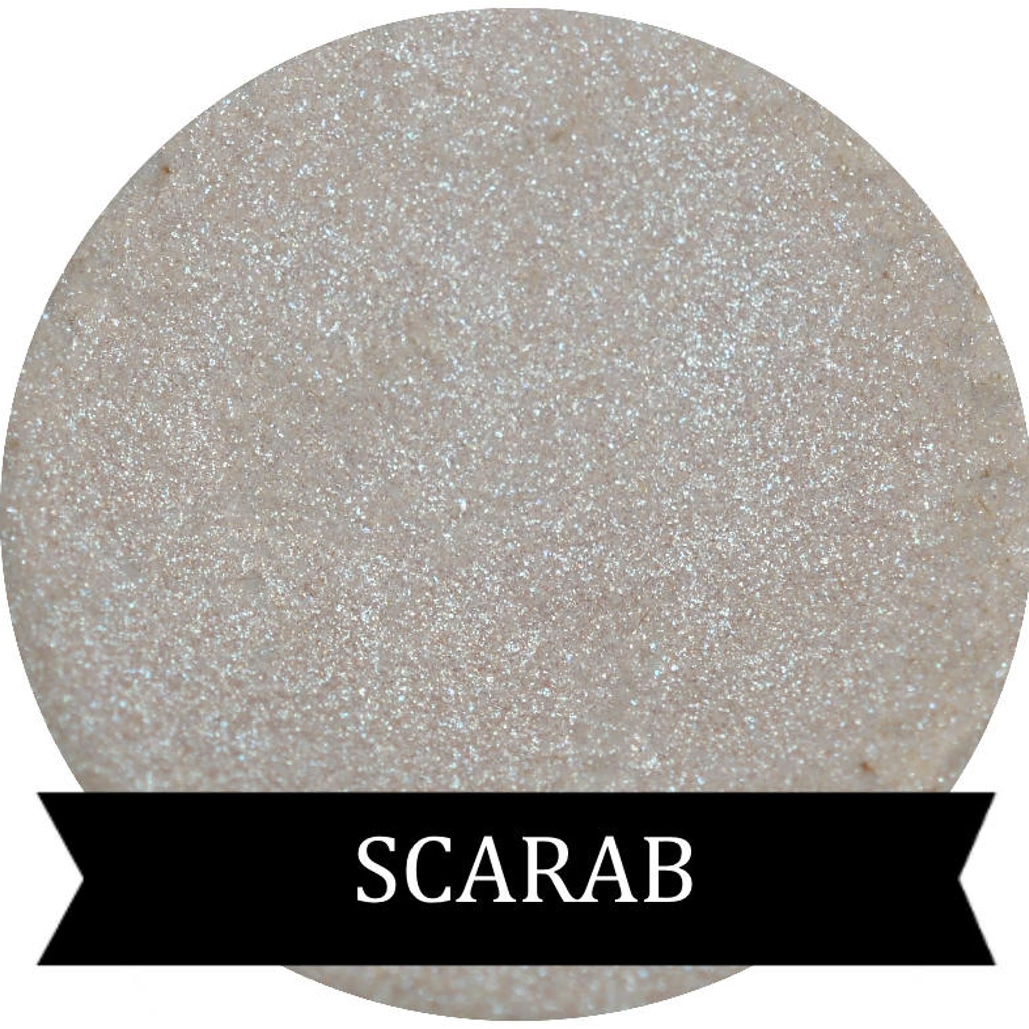 Scarab green iridescent eyeshadow in compact with reflective shimmer and emerald undertones.