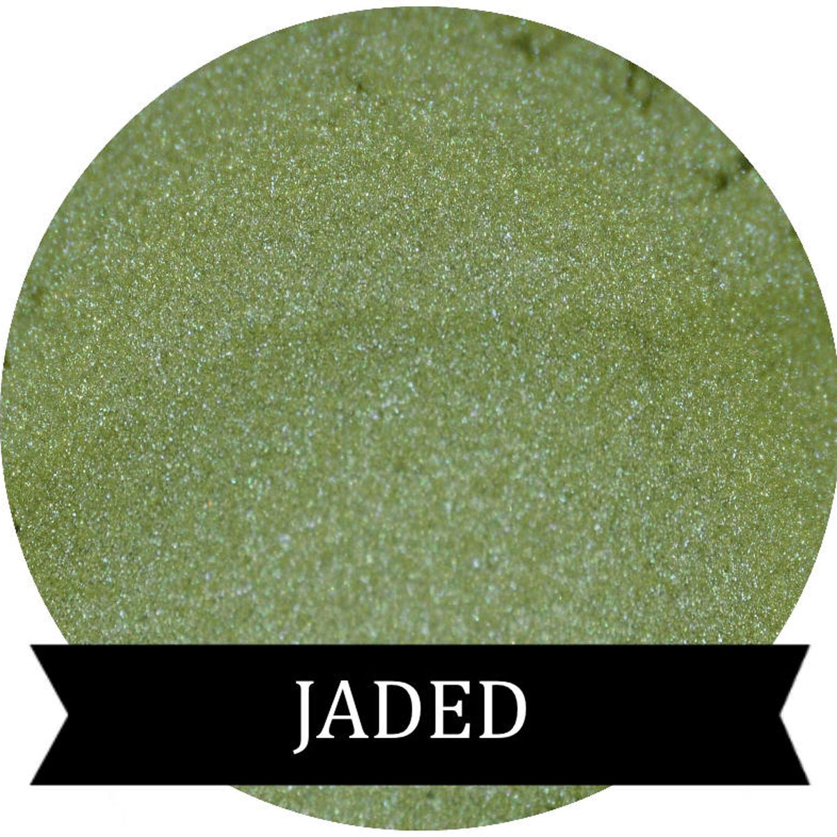Close-up of jade green pressed powder eyeshadow in sleek black compact with gold lettering