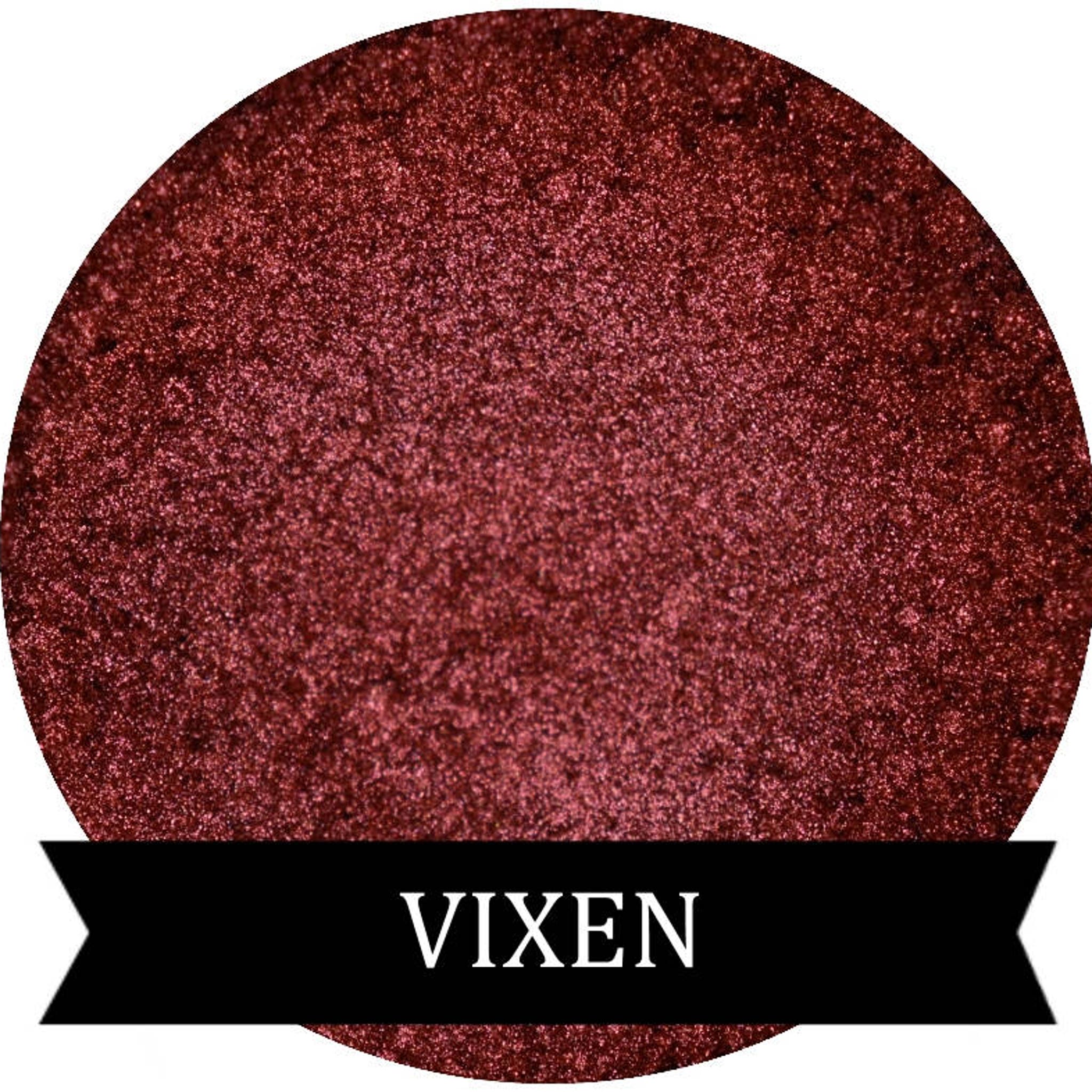 Vixen metallic red eye shadow pot with reflective finish and sleek black compact.