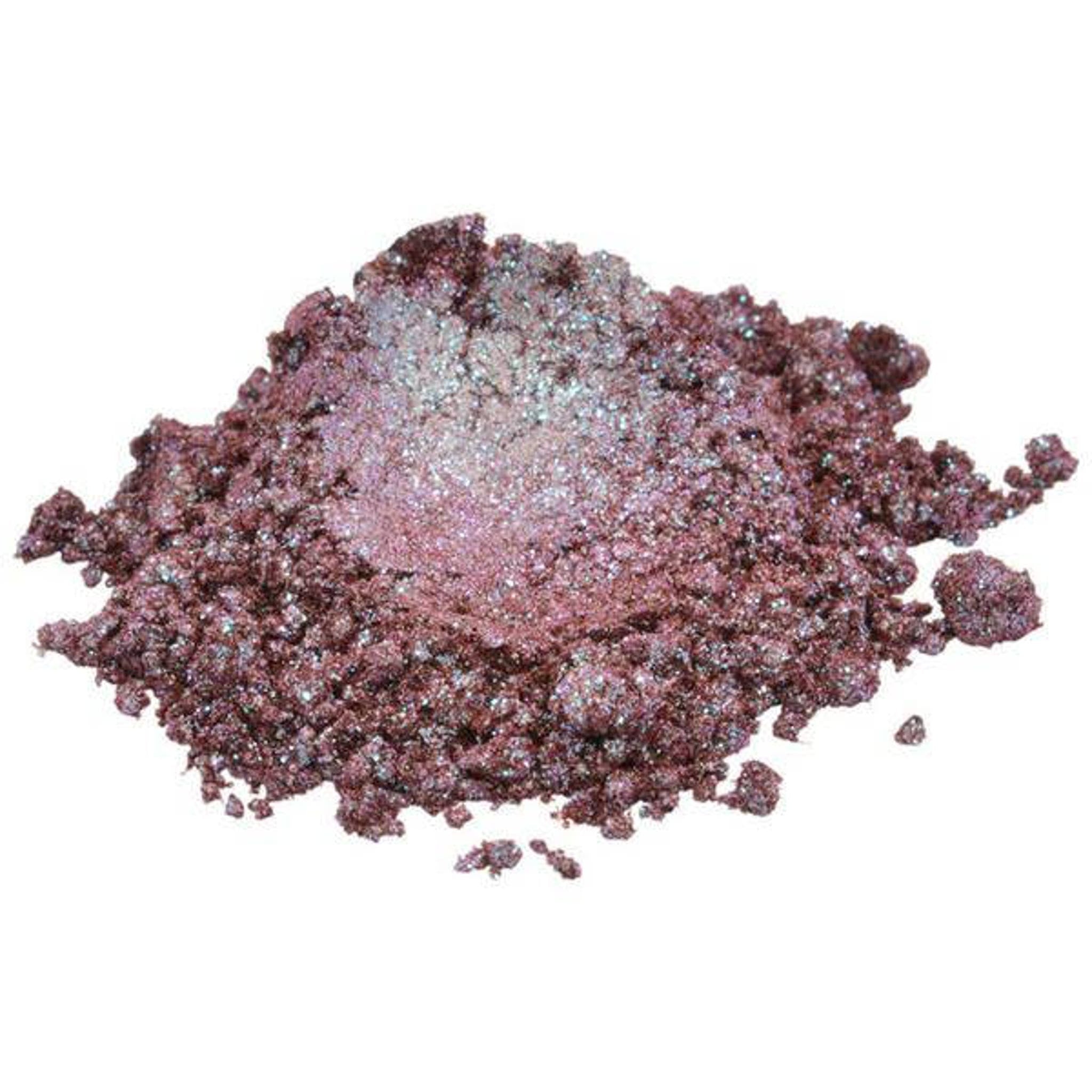 Shimmer eyeshadow powder in dark pink, purple, and silver glitter particles