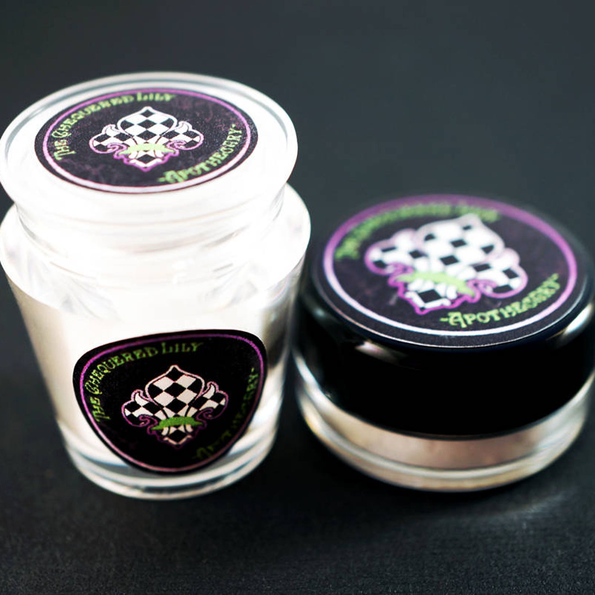 Dark peacock teal loose eyeshadow with matte finish from vegan mermaid collection, shown in open jar