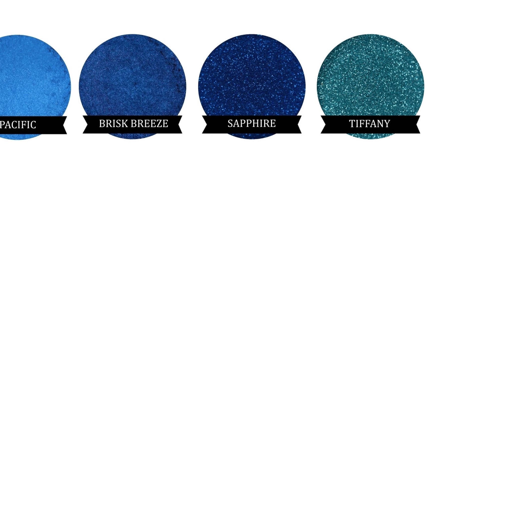Blue and teal glitter eyeshadow swatches with color names on black banners