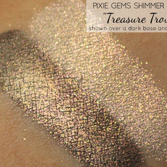 Side view of holographic gold eye shadow dust in round pot, showcasing shimmer particles catching light