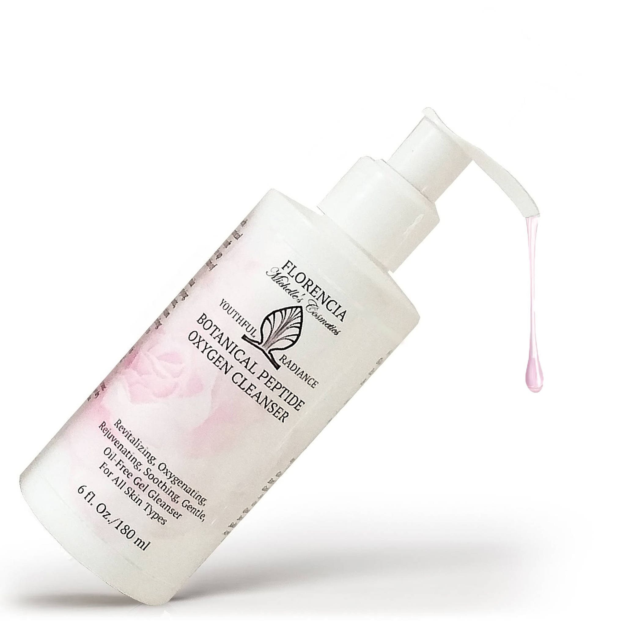 Oxygen cleanser bottle with white and pink floral design, white pump, and pink liquid dripping from the spout