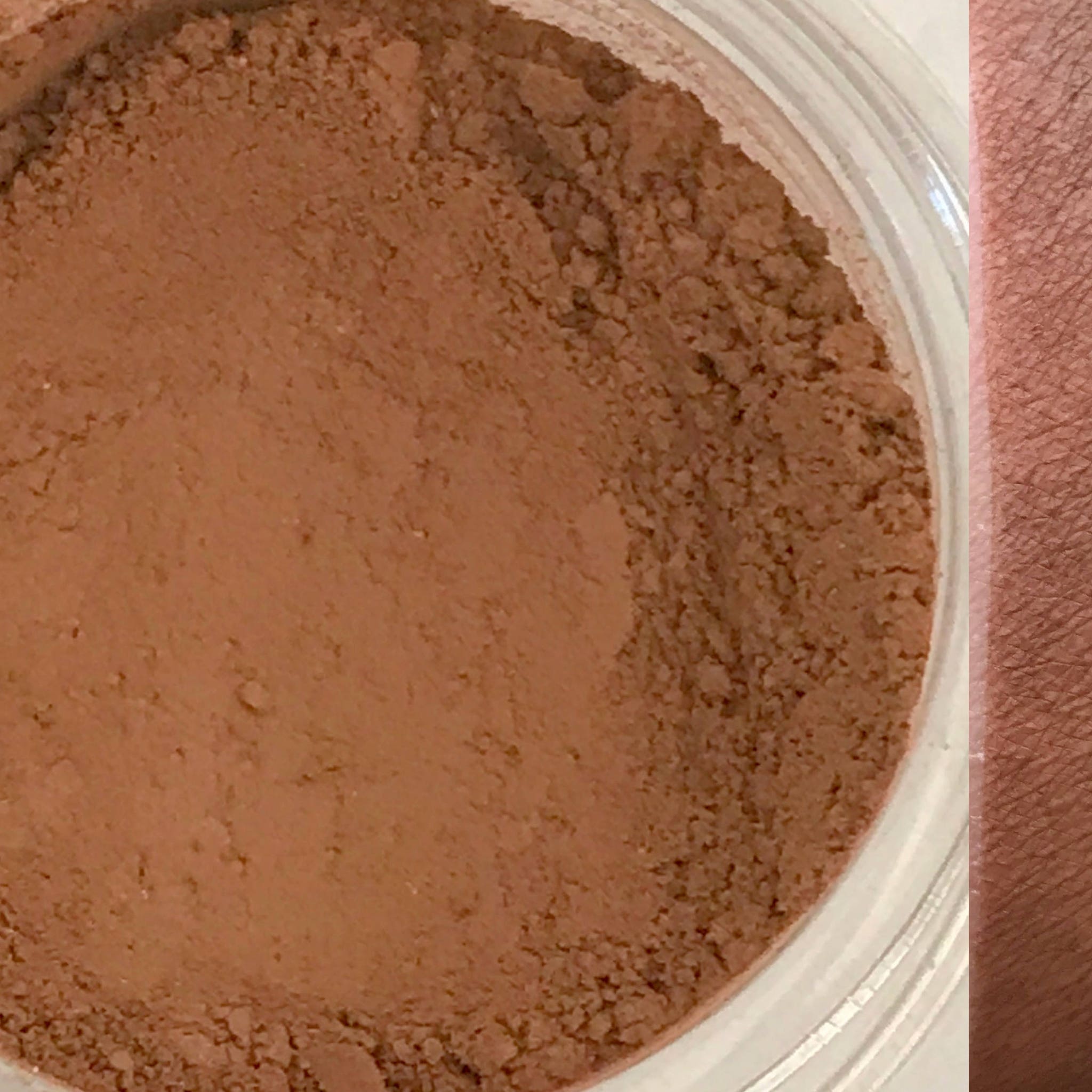 Front view of warm gingerbread brown matte eyeshadow pan in round compact with vegan label