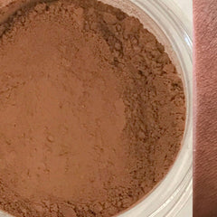 Front view of warm gingerbread brown matte eyeshadow pan in round compact with vegan label