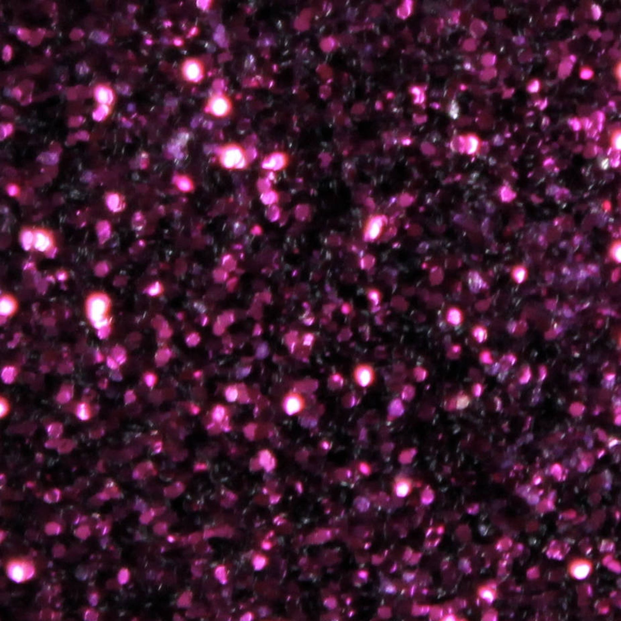 Side view of purple glitter eyeshadow palette with shimmer particles and compact mirror inside