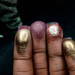 Close-up of vegan gold holographic eyeshadow pan showing shimmering mineral pigment texture