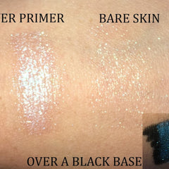 Close-up of fingertips applying shimmery champagne eyeshadow to eyelid with natural glitter particles