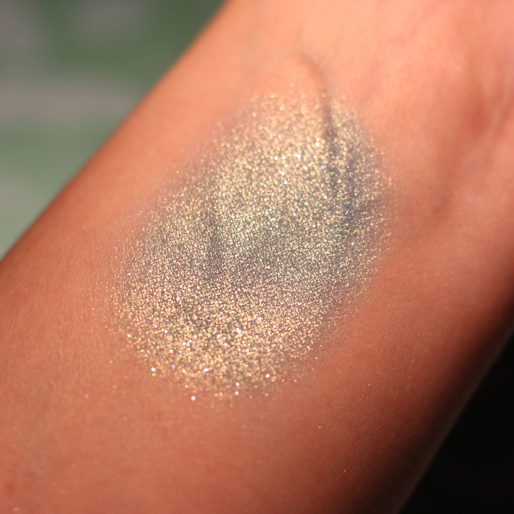 Atlantis Eye Shadow compact open with shimmering teal powder and mirrored interior.
