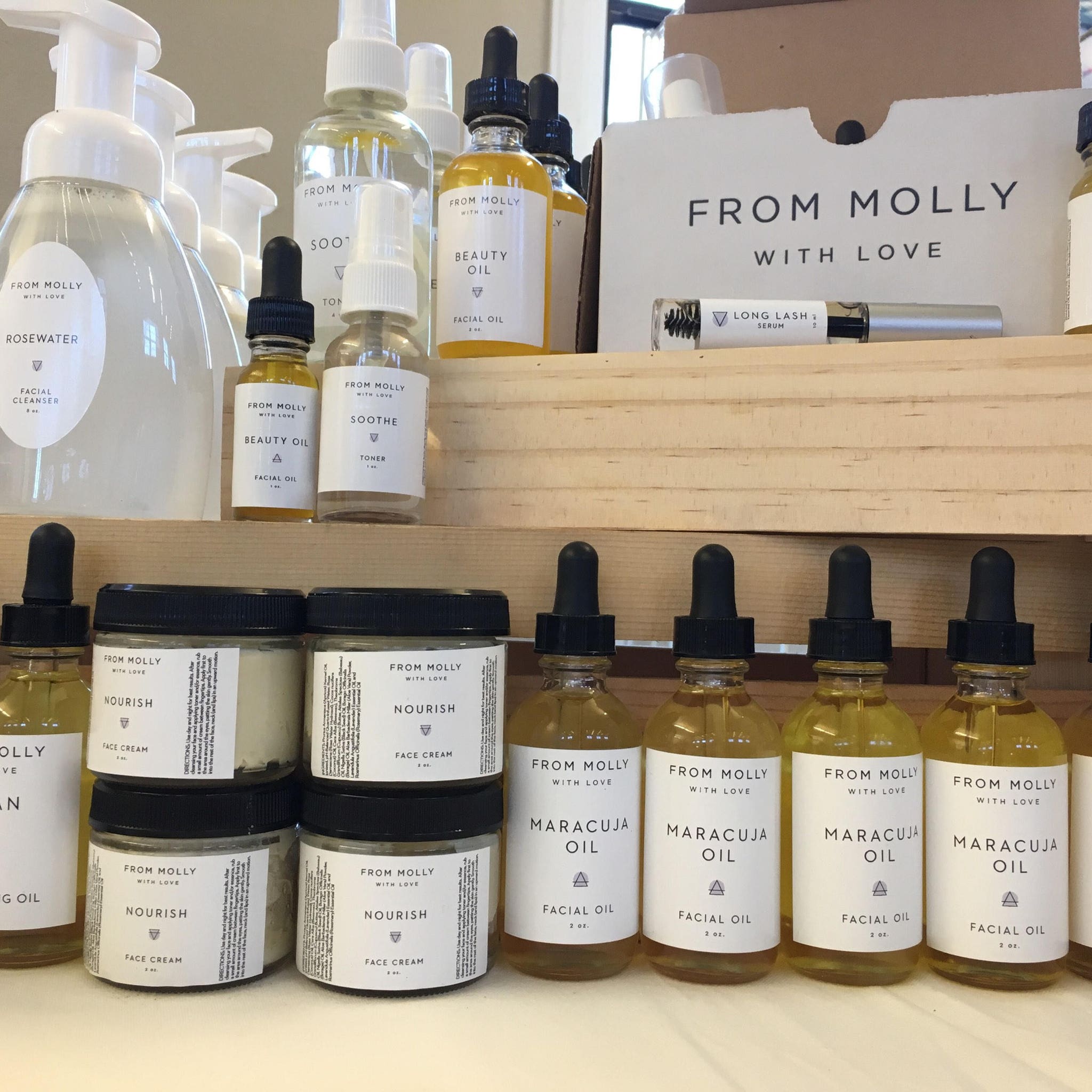 Facial oil bottles with yellow liquid, black droppers, and white labels from From Molly with Love