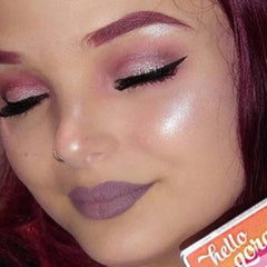 Close-up of pink shimmer eye shadow powder with rosy undertones in a sifter jar
