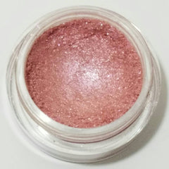 Soft pink mineral eyeshadow in compact case with smooth matte finish and subtle shimmer particles