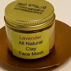 Clay face mask jar with gold lid and label, on a gold-colored plate, "Nana's Naturals" brand