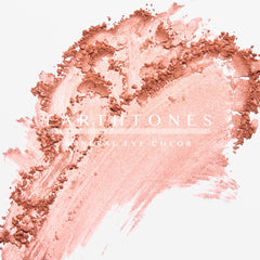 Hand applying rosy shimmer mineral eye shadow with fingertip for a soft blended look