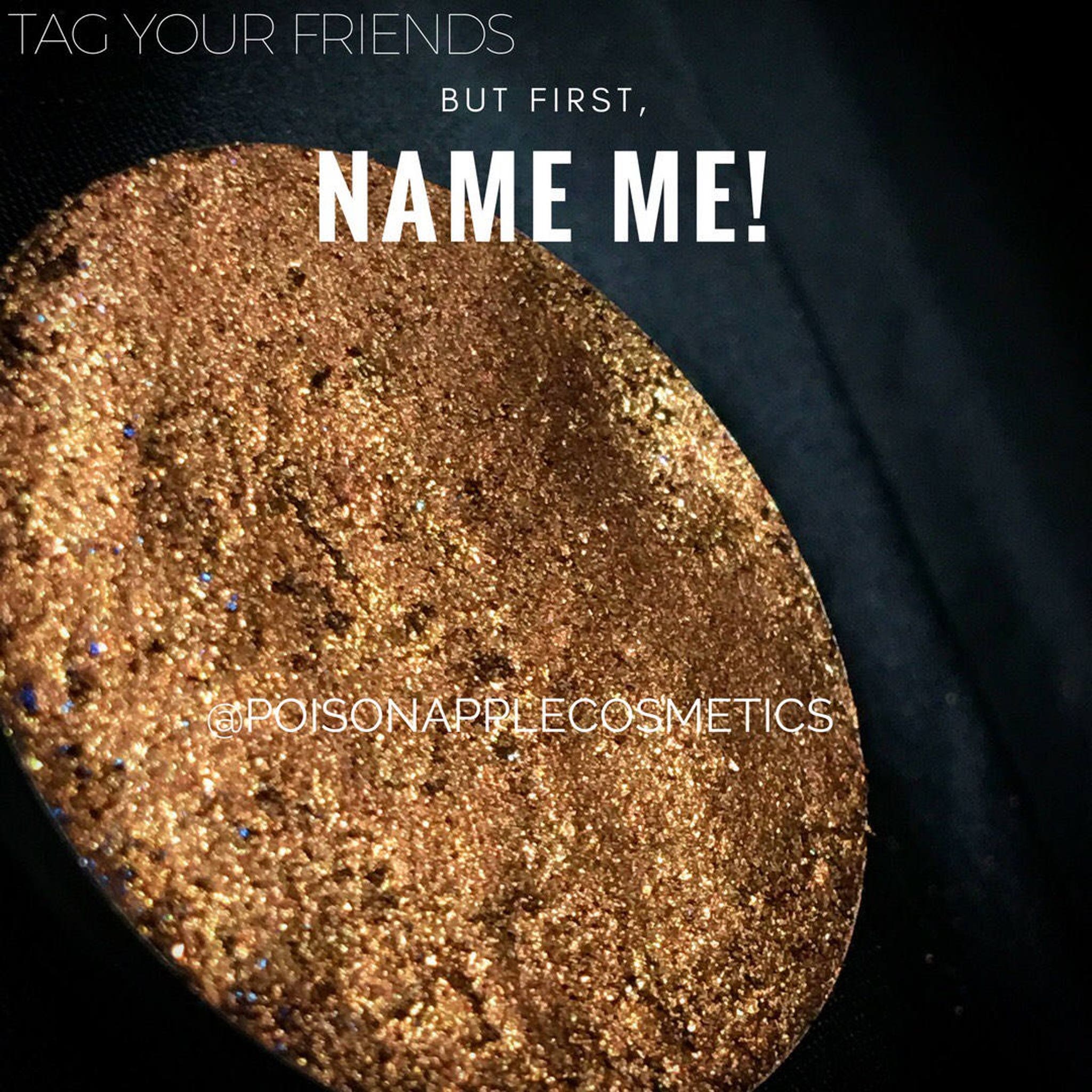 Gold holographic eyeshadow pan with shimmering reflective particles in compact case