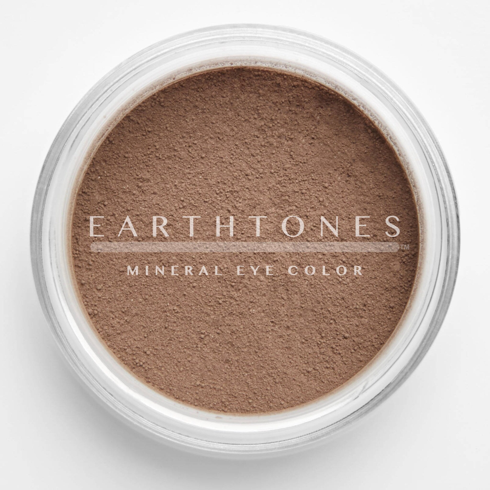 Close-up of rich chocolate brown mineral eye shadow with smooth, velvety texture in compact case