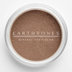 Close-up of rich chocolate brown mineral eye shadow with smooth, velvety texture in compact case