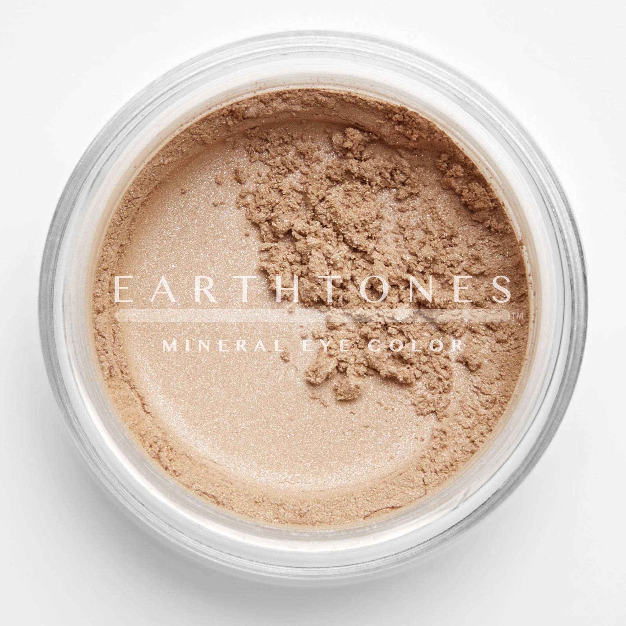Peach shimmer mineral eye shadow in compact with golden lid, showcasing soft powder texture and warm undertones
