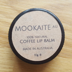 Coffee lip balm with brown paper label and black rim, "MOOKAITE AU" brand name visible