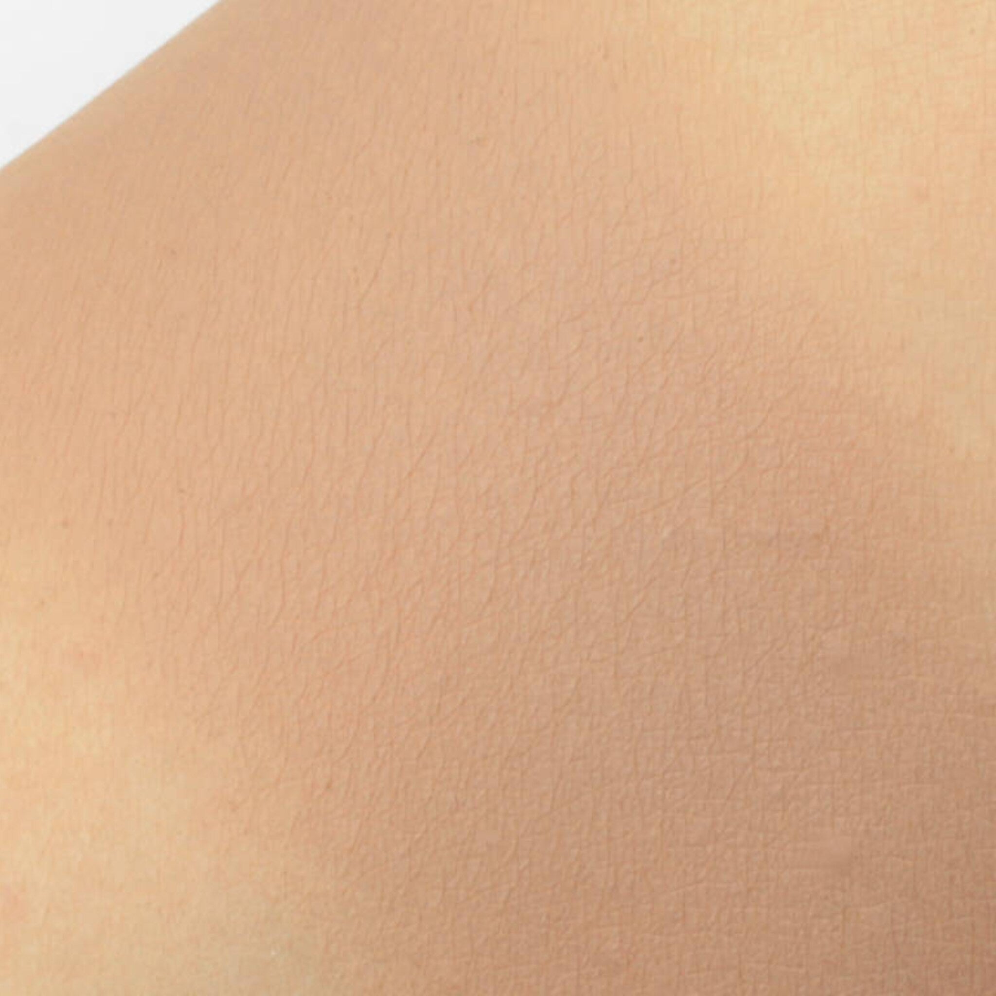Skin texture with light peach color and fine lines visible on the surface