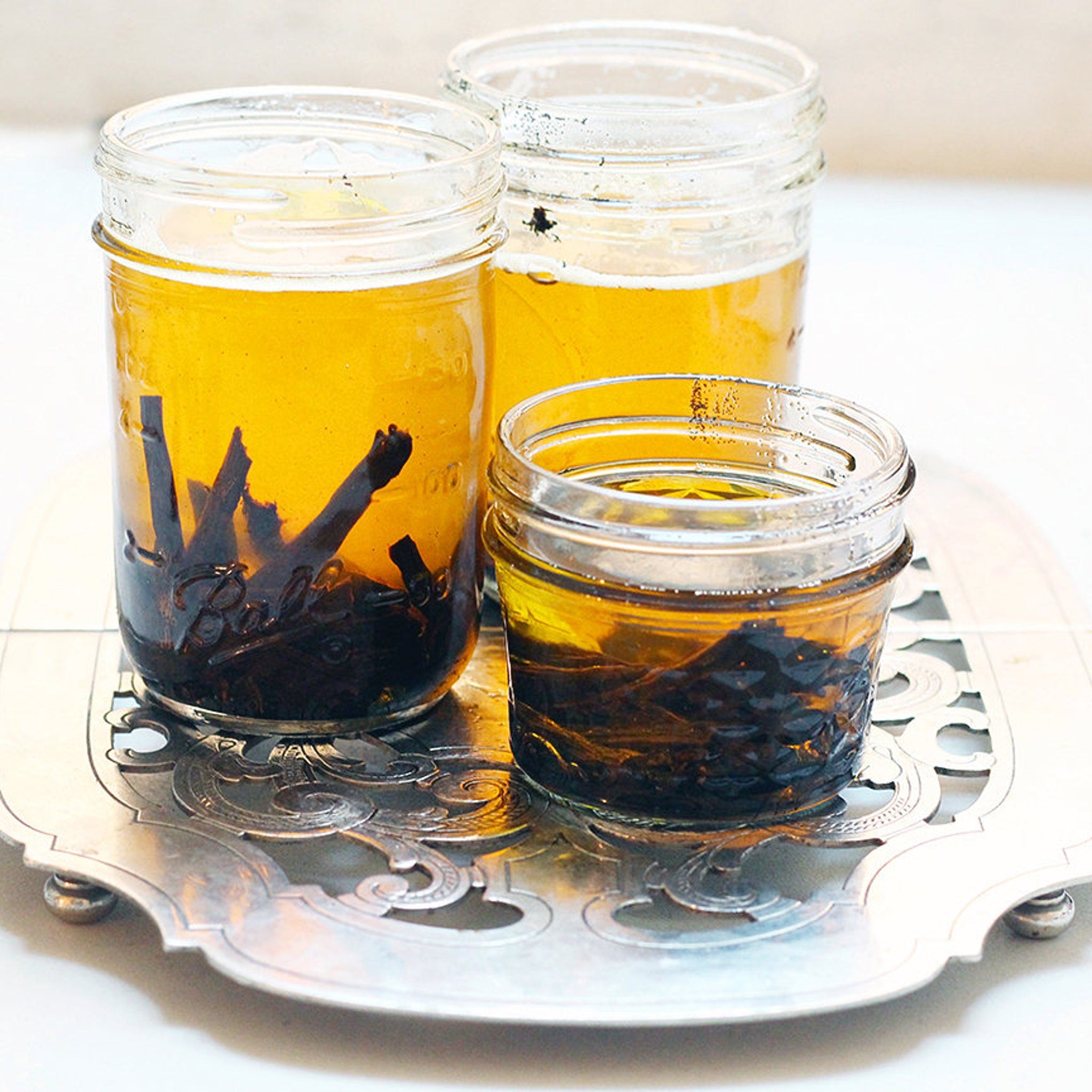 Elegant amber glass jar of vanilla butter moisturizer with gold lid, showcasing silky texture and organic label
