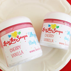 Side angle of cherry vanilla whipped body butter in a pastel pink jar with gold lid, showcasing its fluffy texture