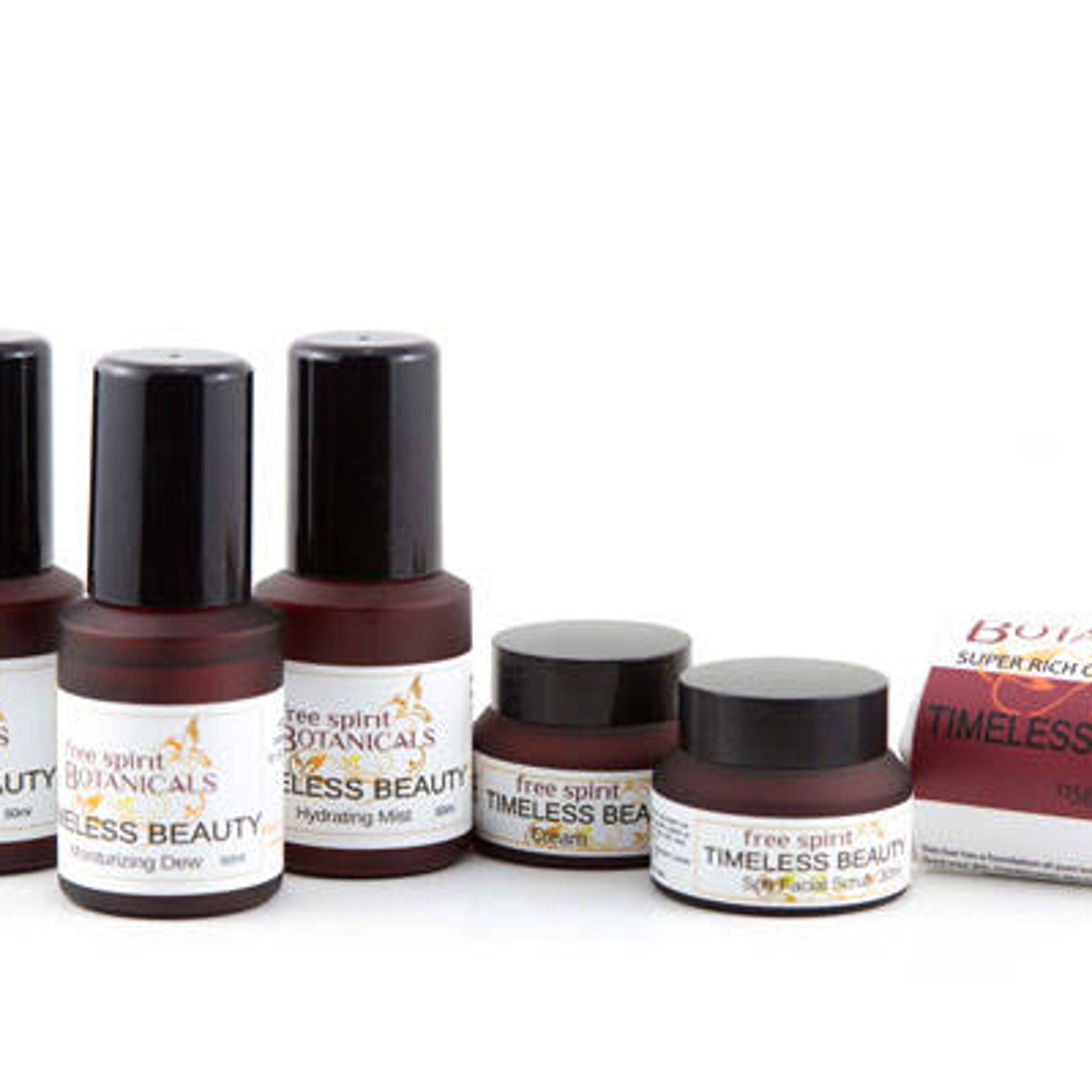 Skincare products in brown bottles and jars with black caps, Timeless Beauty label visible