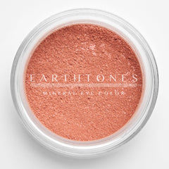 Close-up of shimmery rose pink mineral eye shadow with sparkling flecks in compact pan