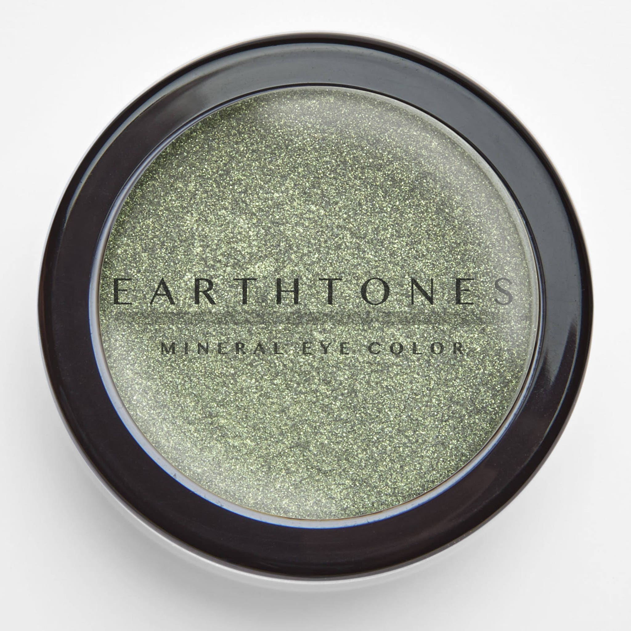 Close-up of fingertips applying mint shimmer mineral eye shadow to eyelid, showcasing soft shine finish
