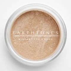 Close-up of peach shimmer mineral eye shadow with sparkling flecks in compact pan
