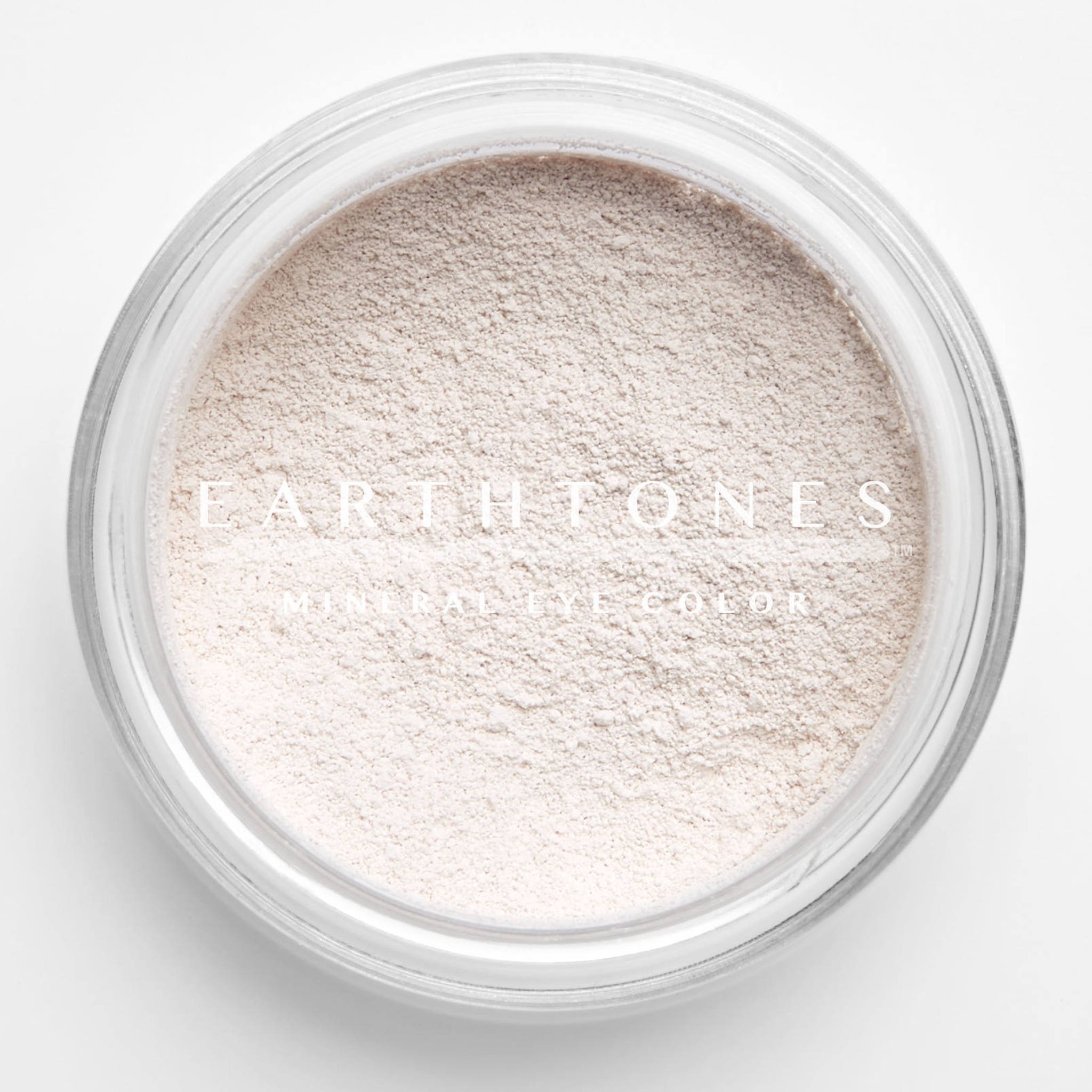 Close-up of soft vanilla mineral eyeshadow with smooth, powdery texture in a compact case