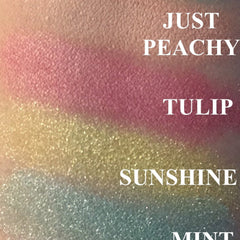 Side angle view of Just Peachy peach eyeshadow compact showing satin finish and warm coral hue