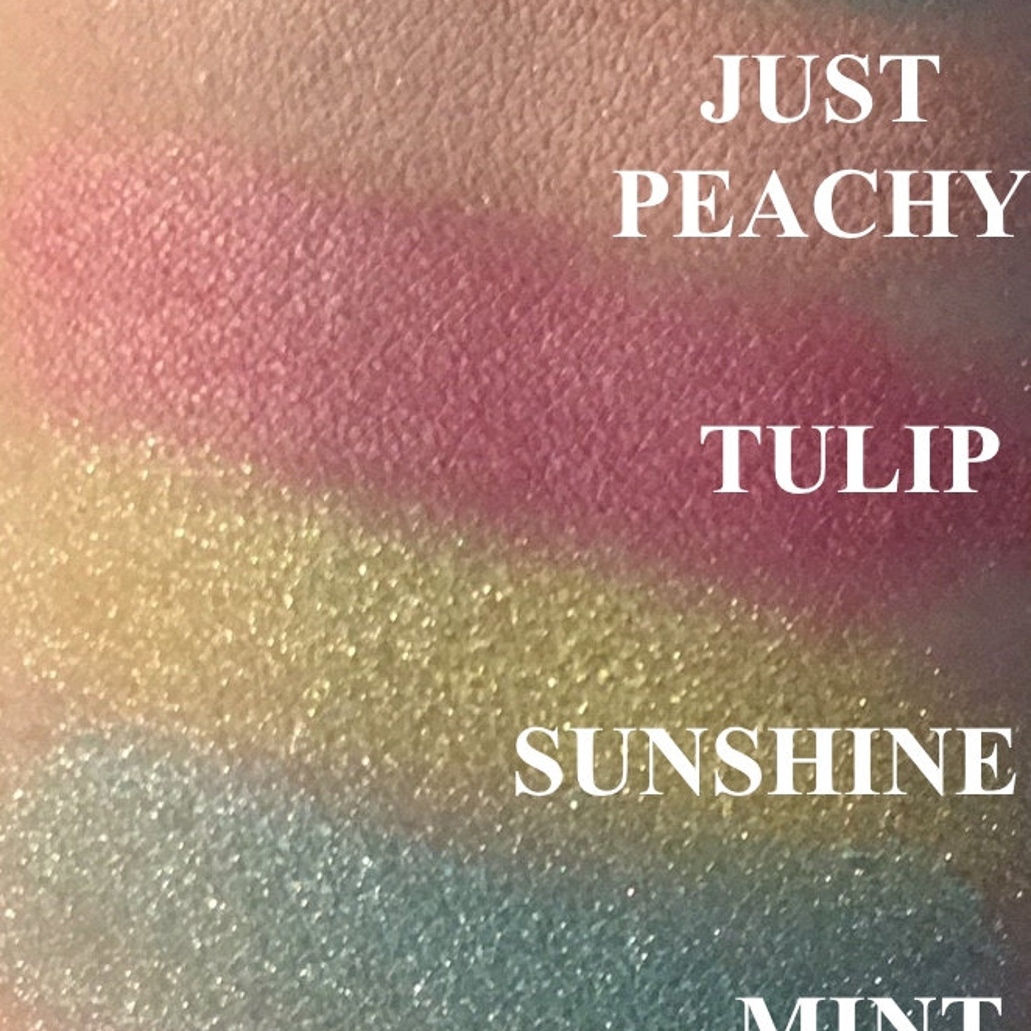 Open compact showing mint green eyeshadow pan with mirrored lid reflection