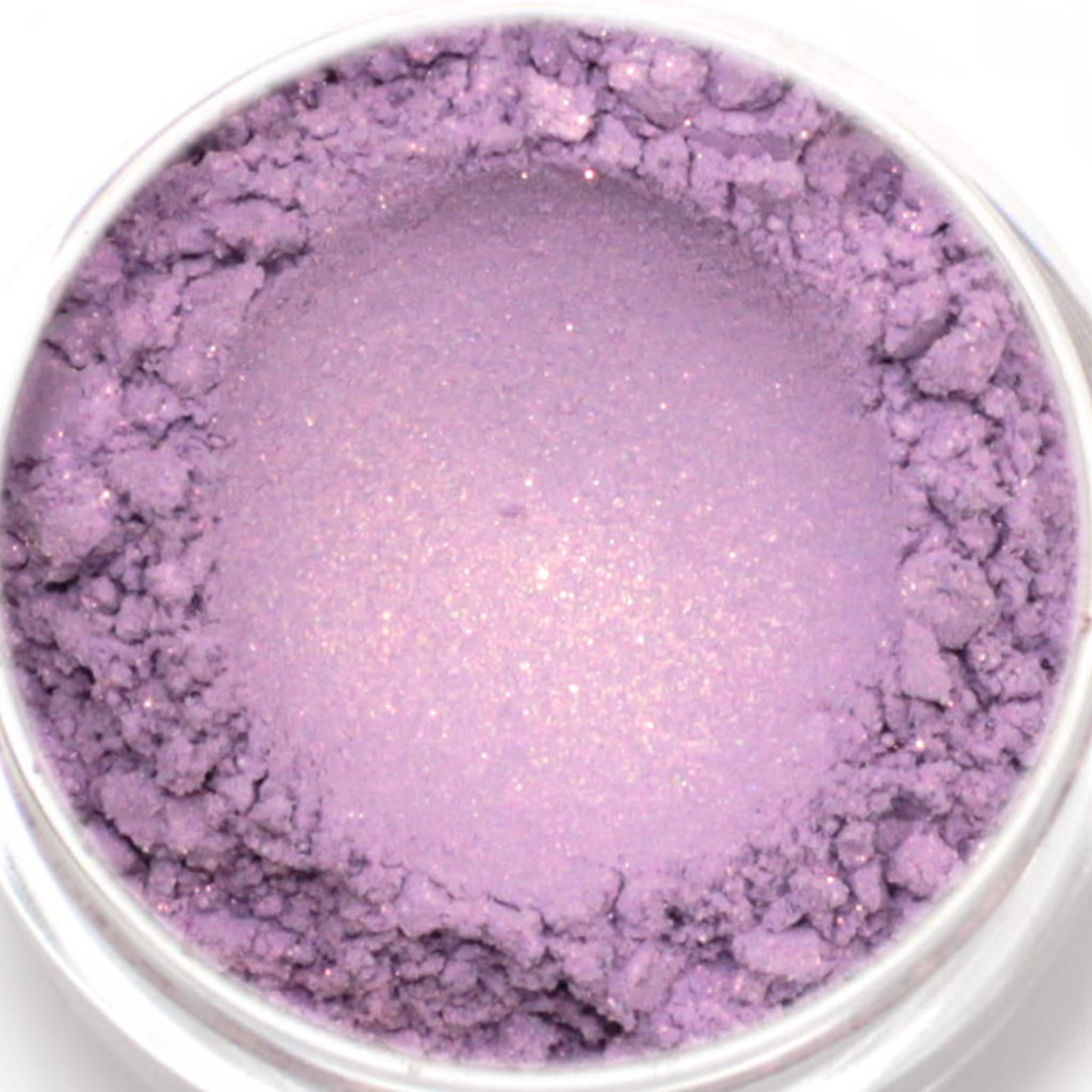 Eyeshadow powder, light purple, shimmering, fine texture in a clear jar