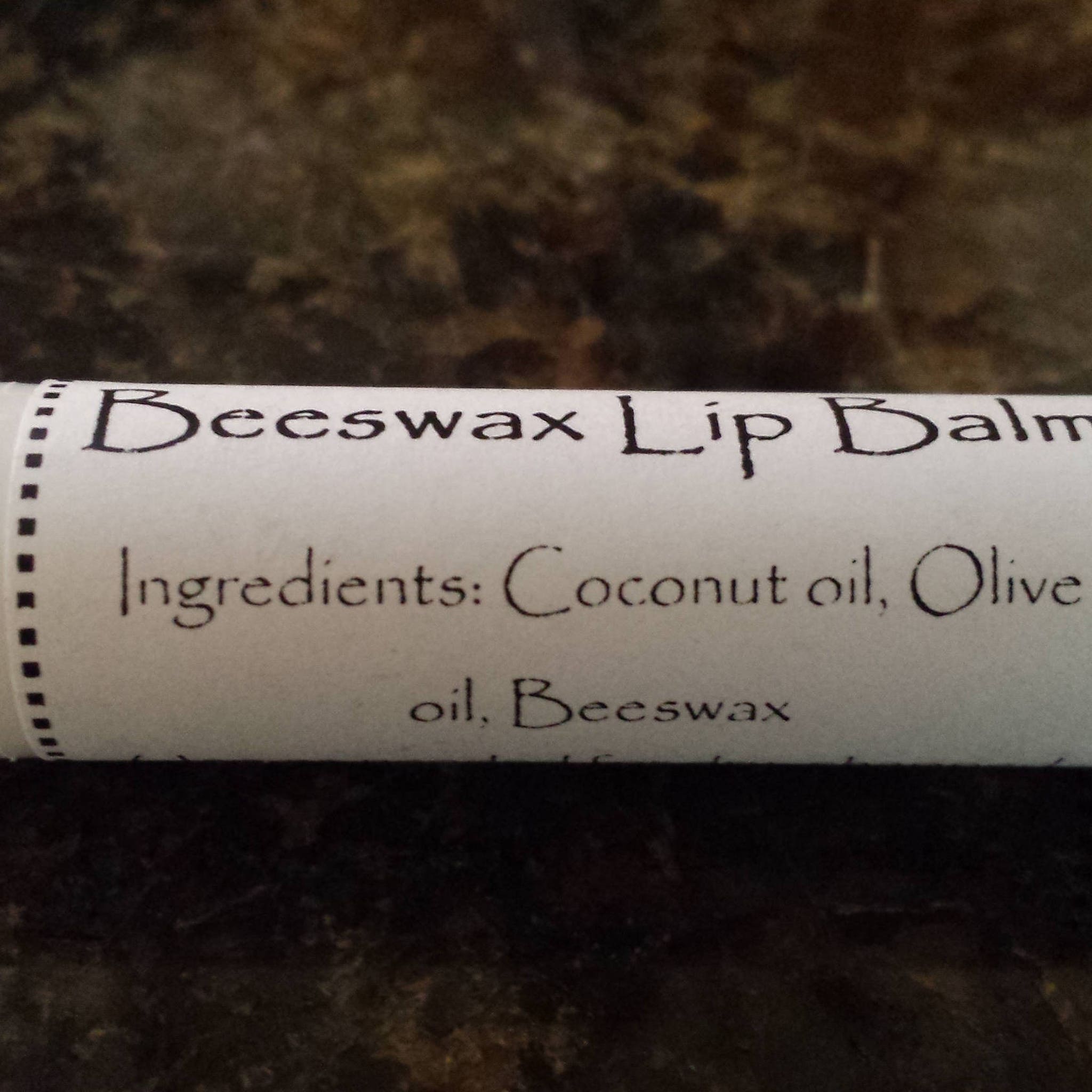 Beeswax Lip Balm white paper tube with black text, ingredients listed, Crooked River Naturals product