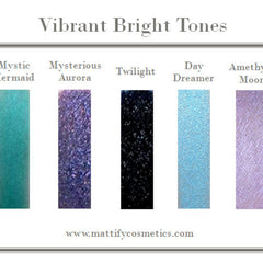 Vegan mermaid eye shadow palette featuring sparkly black, purple, teal, and matte blue shades in sleek black packaging