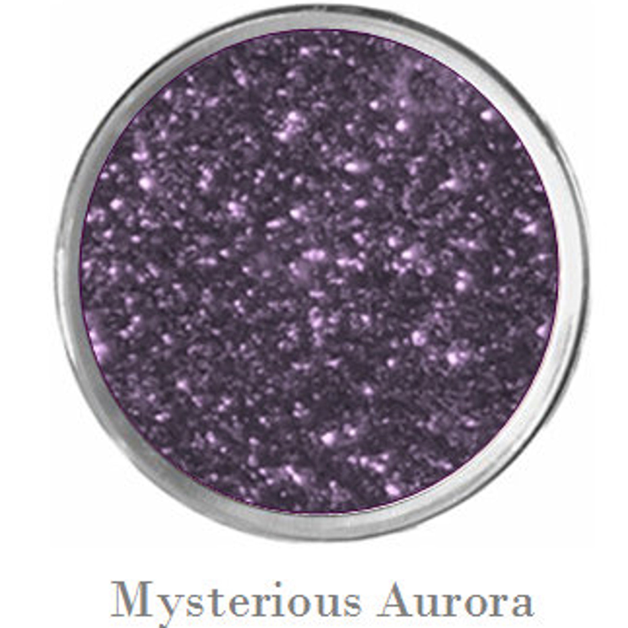 Side view of vegan mermaid eye shadow palette showing sparkly black, purple, teal and matte blue shades in compact case