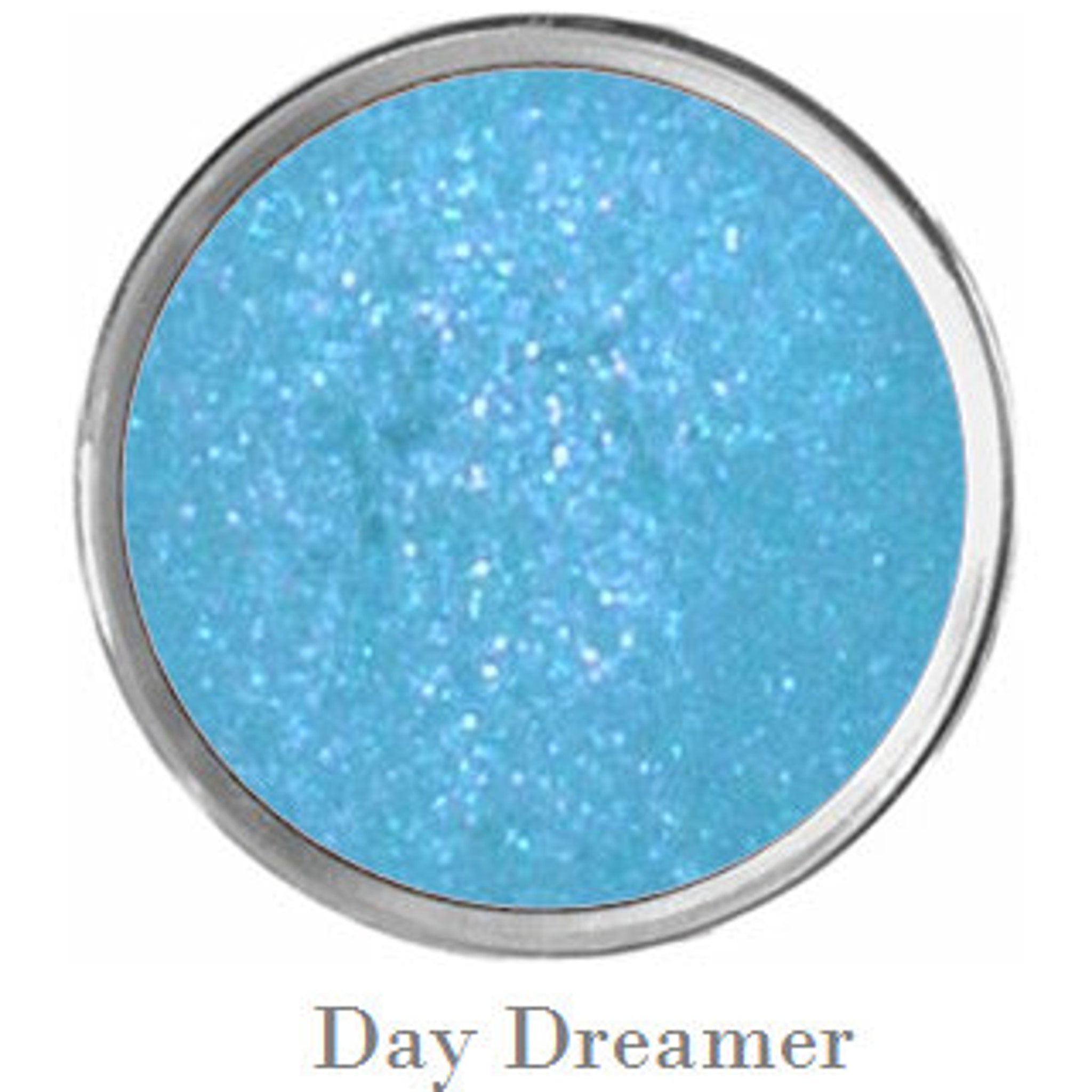 Vegan mermaid eye shadow palette open to show sparkly black, purple, teal and matte blue shades with primer