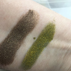 Side view of petite dark brown metallic eyeshadow pan with mineral finish, showcasing texture and sheen