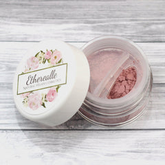 Close-up of matte light pink vegan mineral eyeshadow in compact with smooth, velvety texture and subtle sheen