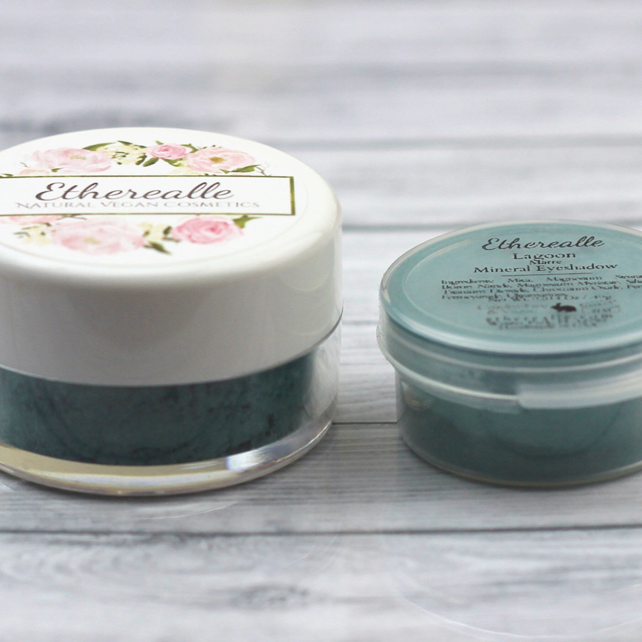 Eyeshadow pots with white and teal lids, floral design, and "Etherealle" text visible on packaging